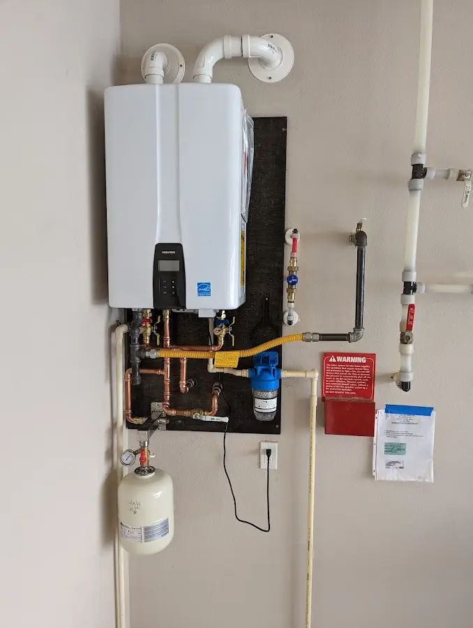 Professional plumber installing copper piping in a Elk Plain home